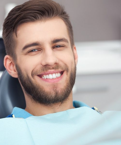 My smile is perfect! Portrait of happy patient in dental chair.